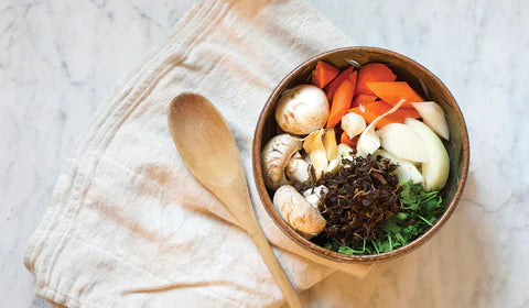 bowl of veggies with tea leaf broth