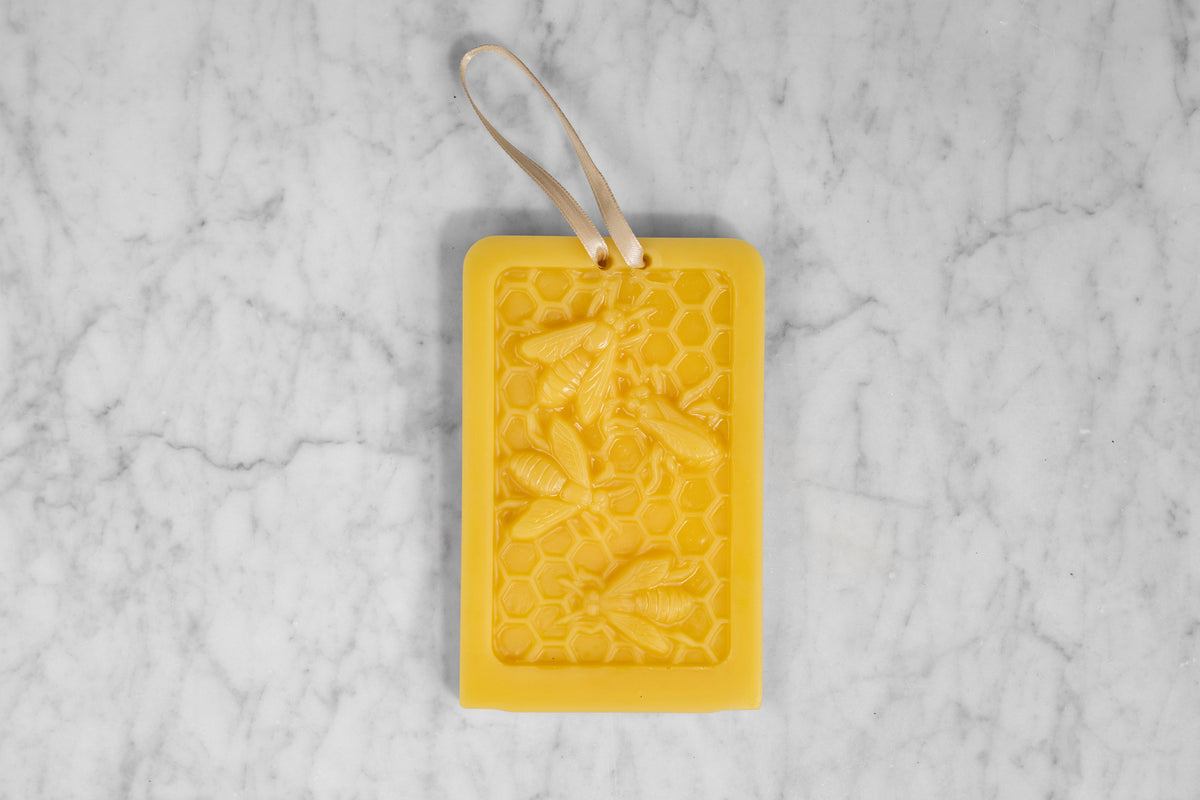 A beeswax ornament designed to look like bees in a hive.
