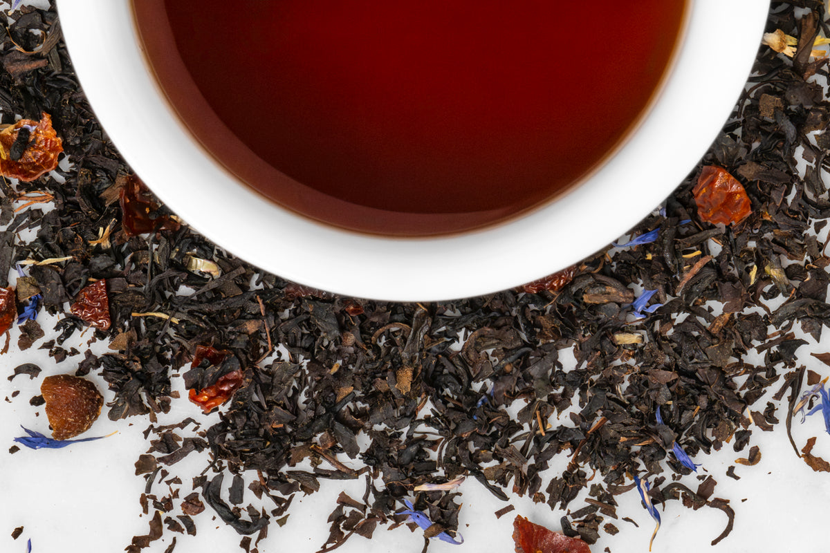 Creme Brûlée dried tea leaves surrounding a cup of black tea.
