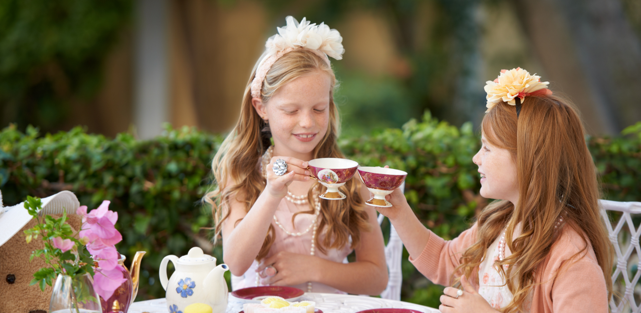 two girls enjoying afternoon tea play time
