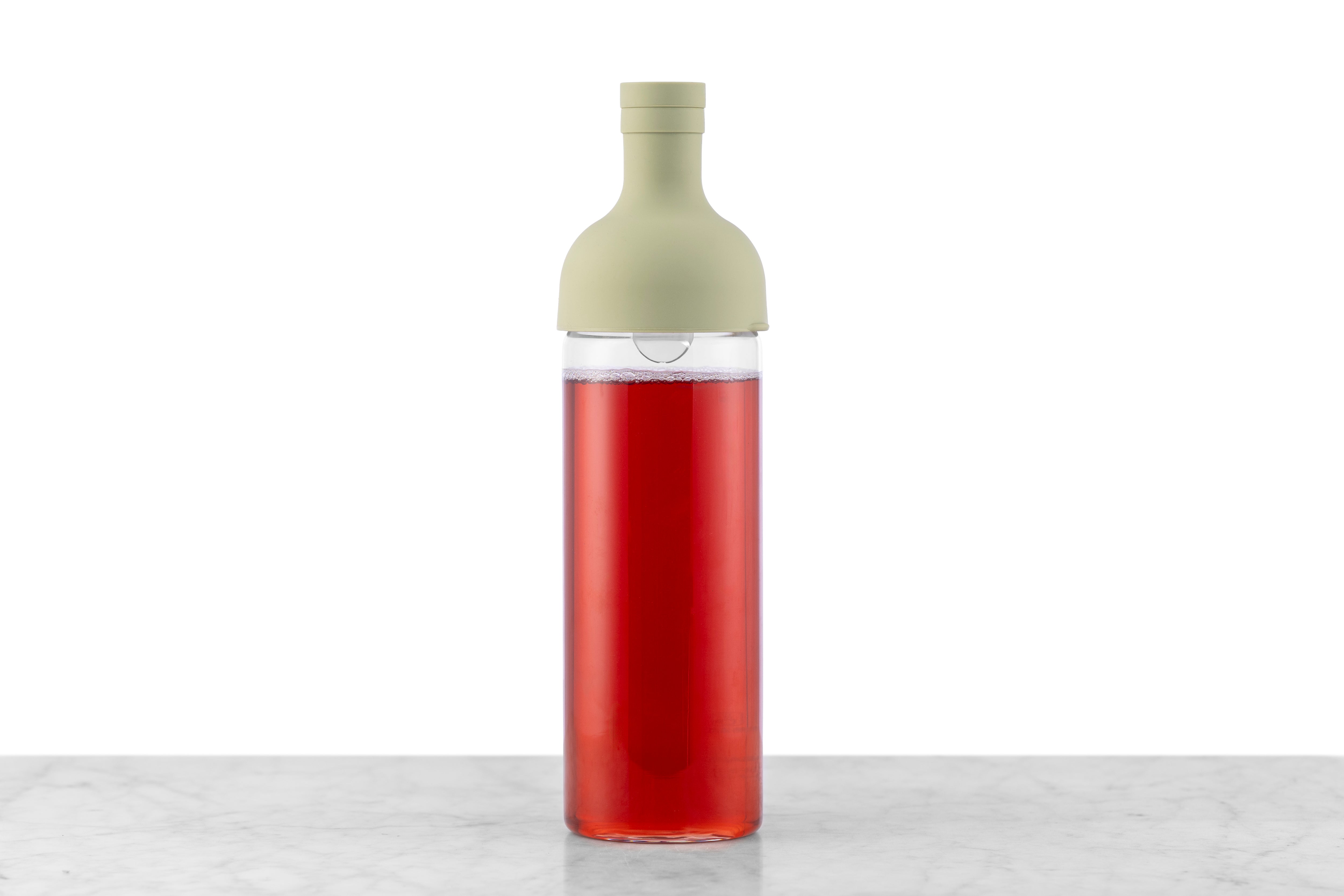 A glass wine bottle-style iced tea maker in Smokey Green.