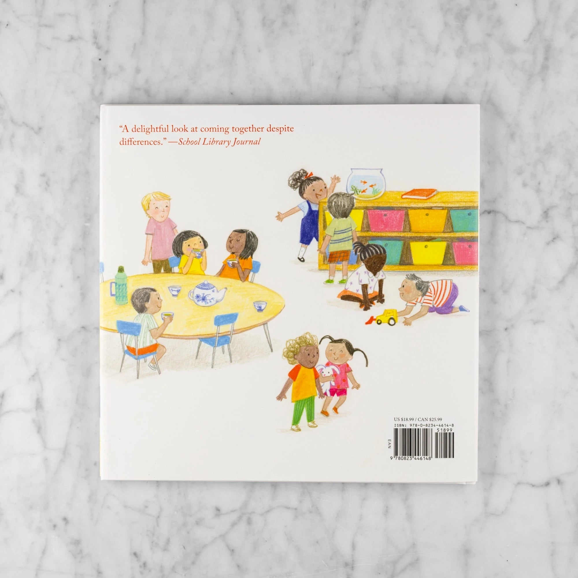Back book cover of Luli and the Language of Tea. Shows children of different races in a classroom playing and drinking tea. Blurb reads: "A delightful look at coming together despite differences." - School Library Journal