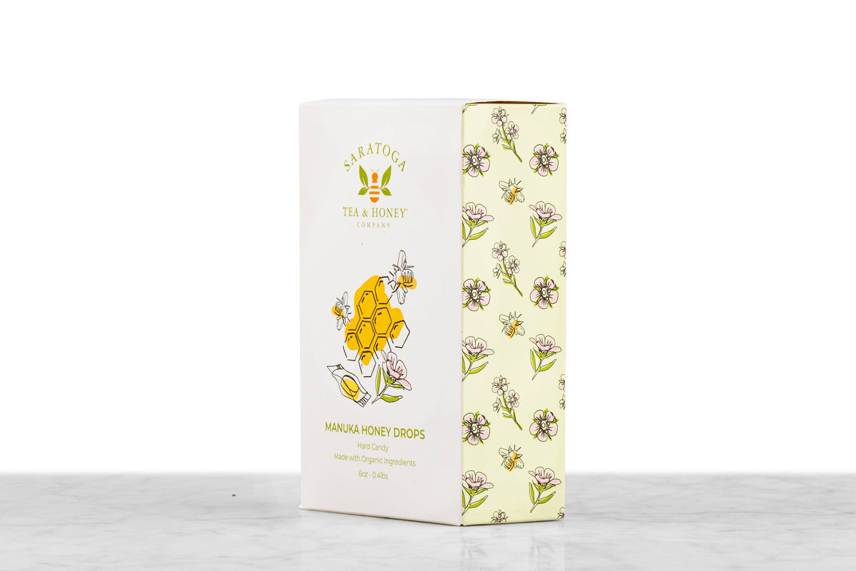 Angled view of Manuka Honey Drops honey candy box from Saratoga Tea & Honey Co. showing front and side design