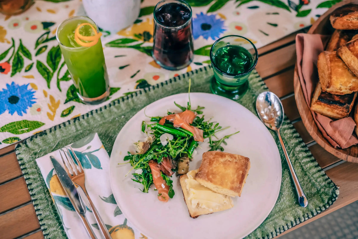 mat-cha-cha cocktail at summer lunch party with plate of salmon salad and biscuit