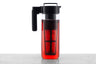 A 2 quart glass iced tea pitcher with a detachable infuser filled with red liquid.