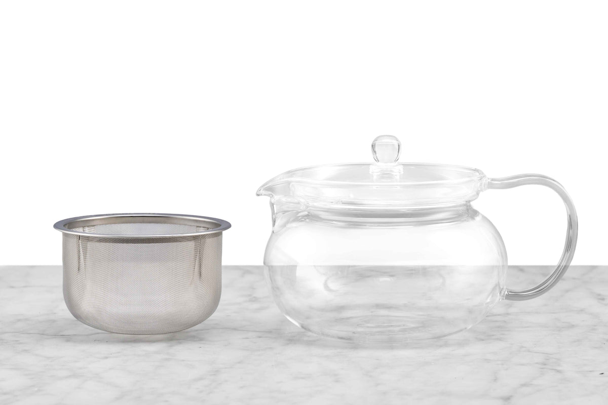 A glass teapot with its metal infuser removed.