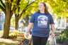 woman walking down the street in blue High Steeps tea pun tshirt from Saratoga Tea & Honey Co.