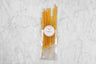 wildflower honey sticks coming out of compostable plastic packaging