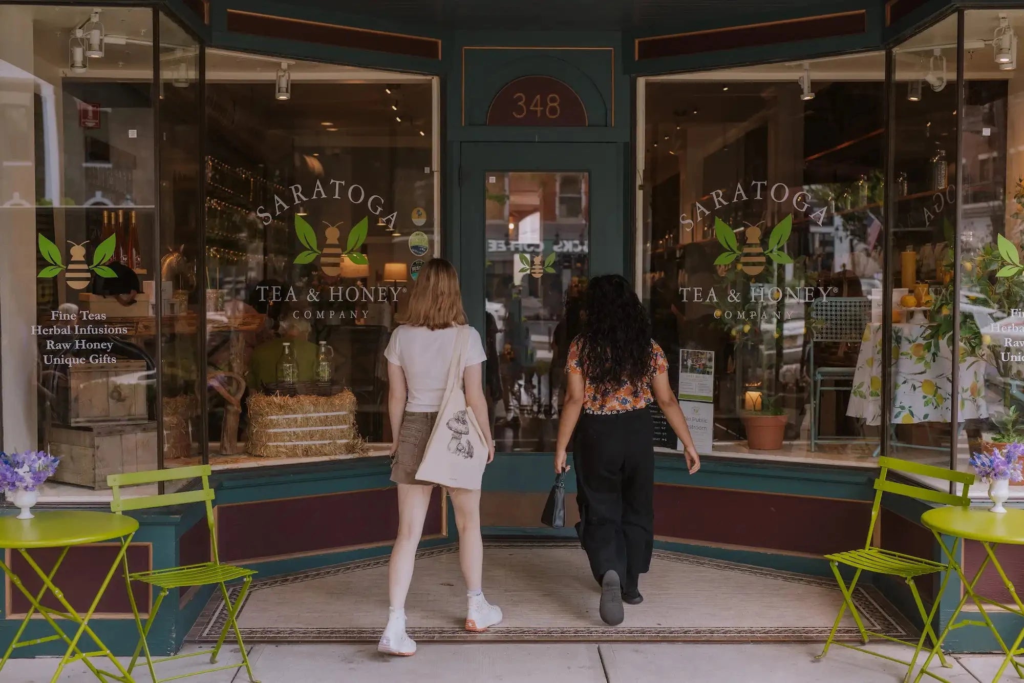 two friends walking into Saratoga Tea & Honey Co. in Saratoga Springs NY