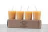 4 beeswax votive candles sitting on a kraft box