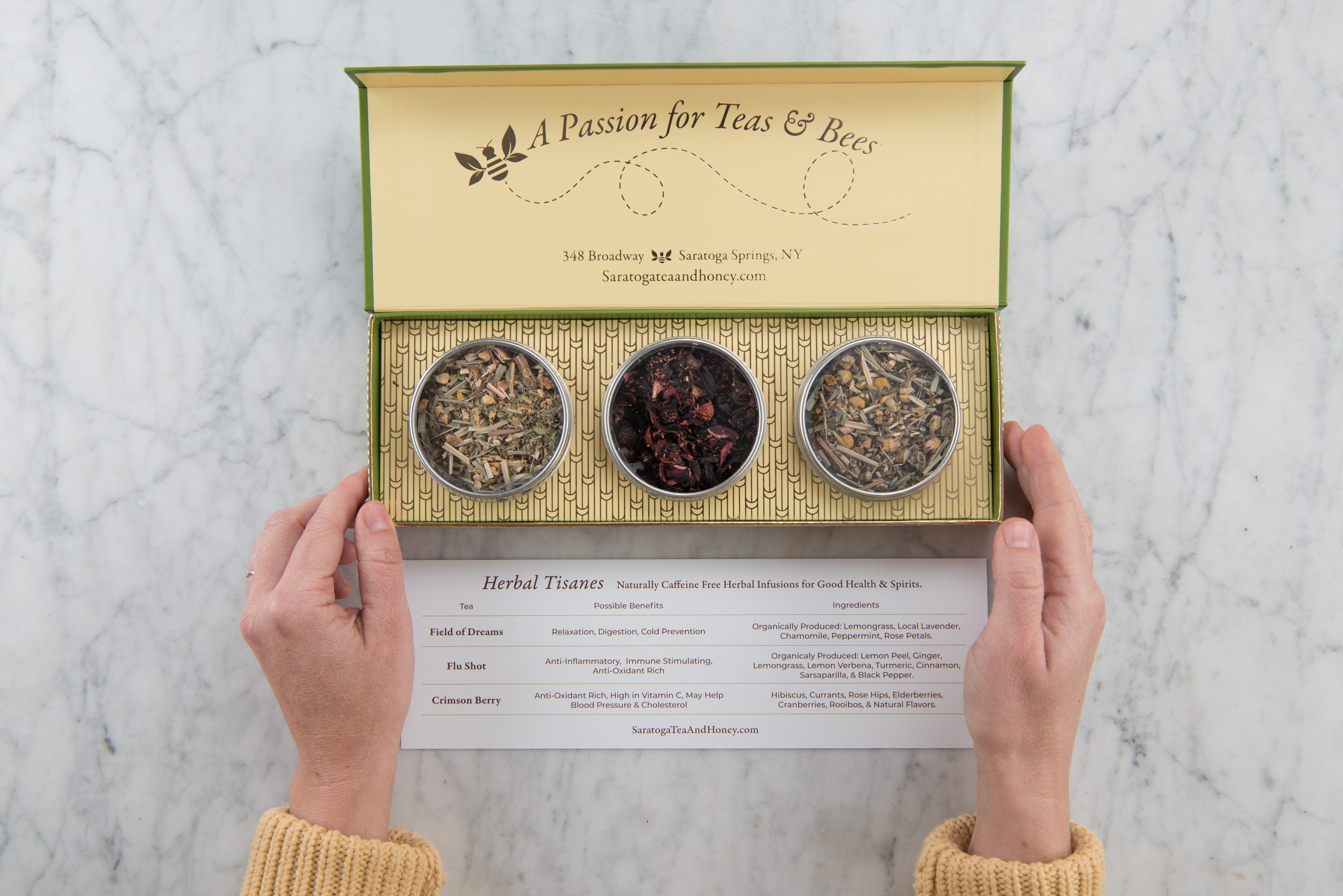 hands opening an herbal tisanes gift box