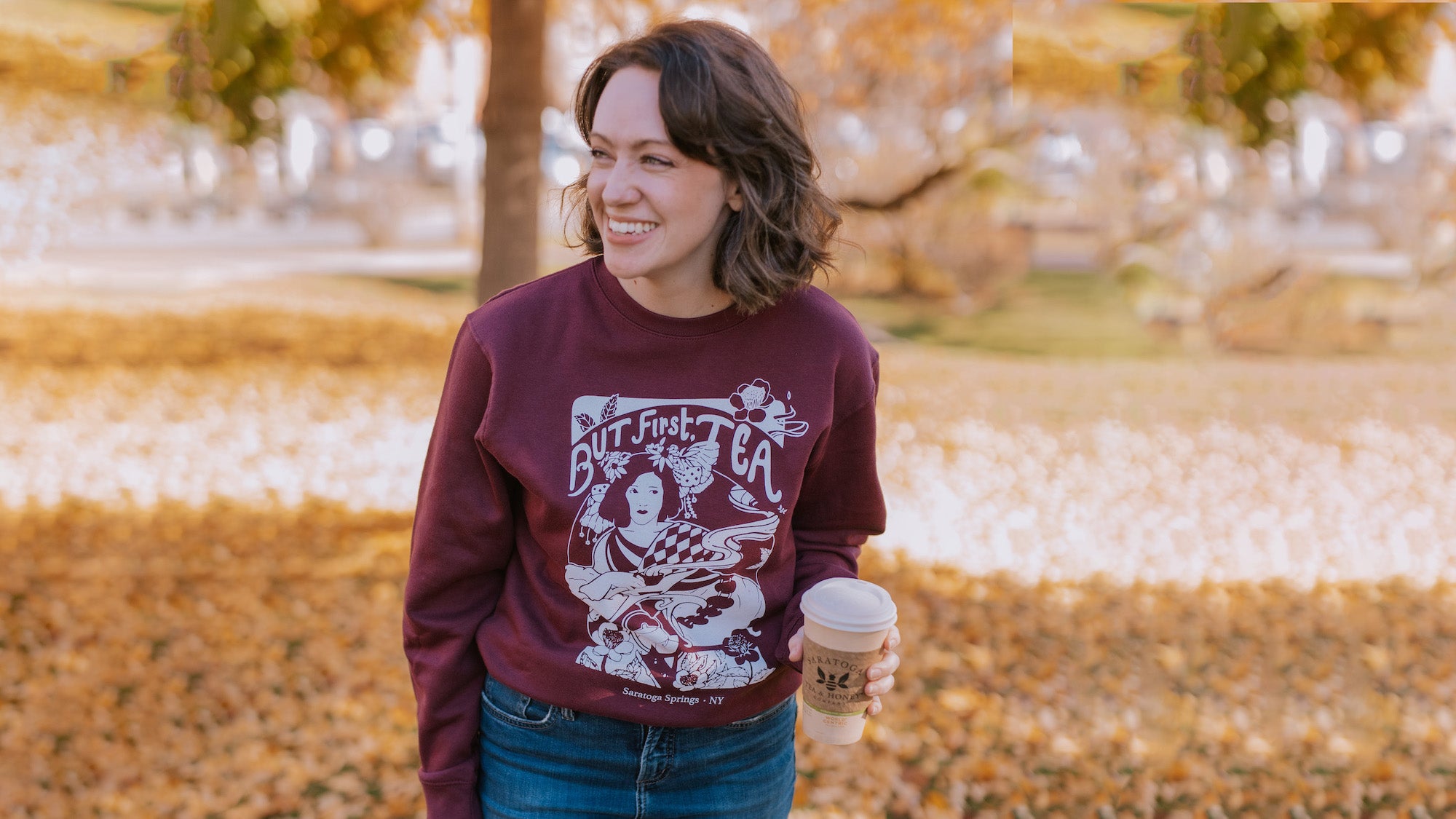 female wearing plum colored "but first, tea" art nouveau style printed sweatshirt