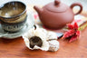 2012 menghai nests of pu erh in front of yixing pot and small tea cups