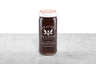 Dark amber Pumpkin Spice Honey displayed in a 12oz cylindrical glass jar with a white lid. The logo and the words: "100% Pure Raw Honey" are printed on the jar.