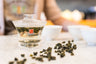 rolled Taiwanese oolong brewing in a glass gaiwan