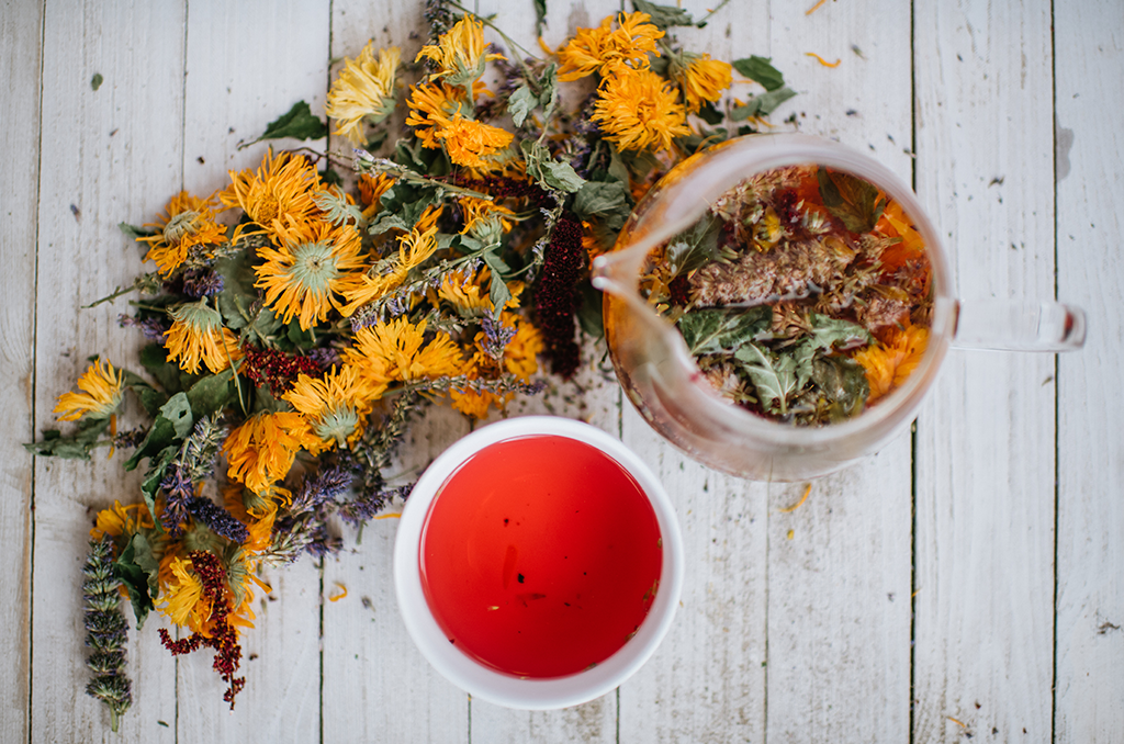 tranquilite relaxing herbal tisane on wood background with teapot and white cup of brewed tranquilite